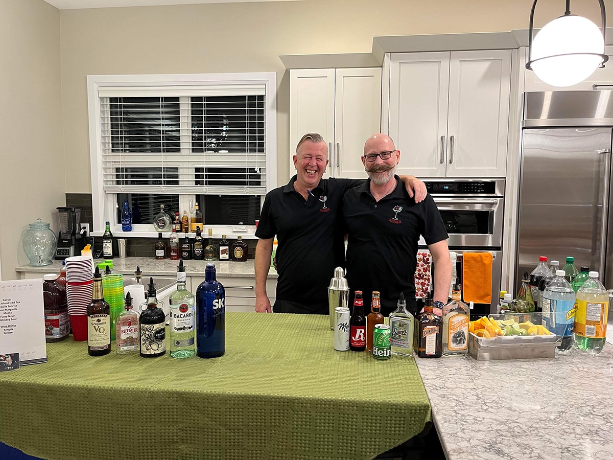 Contact Probartenders, Ottawa bartending company. Picture of Dan Maskell and staff member, serving at a house party